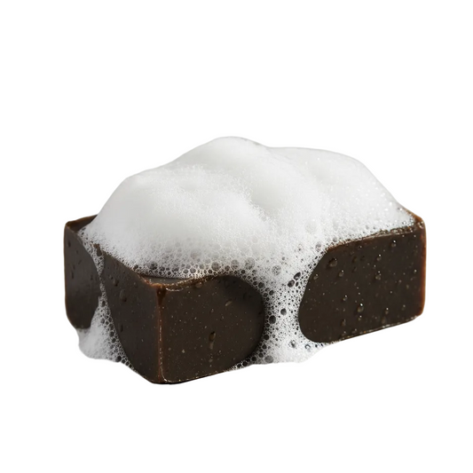 rectangle dark brown bar soap with suds on top